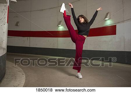 Portrait confident young woman dancing in tunnel View Large Photo Image Stock Photo - Portrait confident young woman dancing in tunnel. Fotosearch