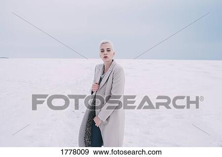 Stock Photo - Portrait confident young woman in snowy landscape. Fotosearch