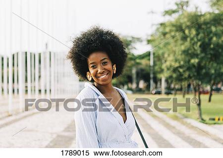 Portrait confident young woman in sunny park View Large Photo Image Stock Photography - Portrait confident young woman in sunny park. Fotosearch