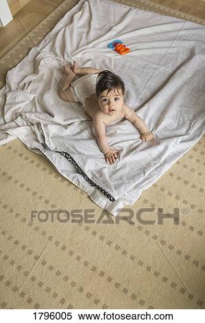 Portrait cute, curious baby boy laying on blanket View Large Photo Image Stock Photography - Portrait cute, curious baby boy laying on blanket. Fotosearch