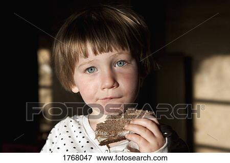 Stock Photo - Portrait cute girl eating sandwich. Fotosearch