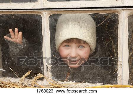 Portrait cute girl in knit hat at window View Large Photo Image Stock Image - Portrait cute girl in knit hat at window. Fotosearch