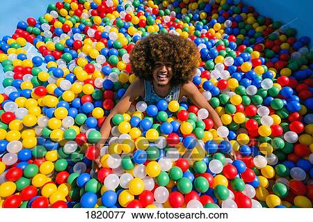 Portrait exuberant young man playing in multicolor ball pool View Large Photo Image Stock Photo - Portrait exuberant young man playing in multicolor ball pool. Fotosearch