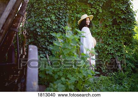Portrait happy pregnant woman standing at ivy covered door View Large Photo Image Stock Image - Portrait happy pregnant woman standing at ivy covered door. Fotosearch