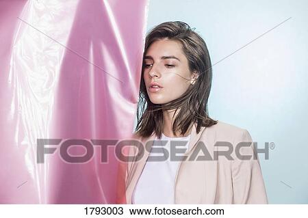 Portrait of a female fashion model posing with pink fabric and looking away View Large Photo Image Stock Image - Portrait of a female fashion model posing with pink fabric and looking away. Fotosearch