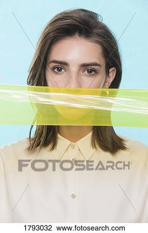Portrait of a female fashion model posing with yellow plastic strip View Large Photo Image Stock Image - Portrait of a female fashion model posing with yellow plastic strip. Fotosearch
