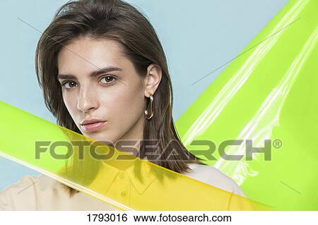 Portrait of a female fashion model posing with yellow plastic sheets View Large Photo Image Stock Photograph - Portrait of a female fashion model posing with yellow plastic sheets. Fotosearch