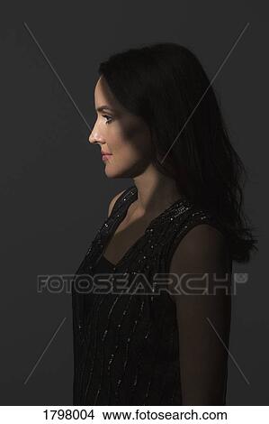 Portrait of beautiful woman in side profile and amidst shadow View Large Photo Image Picture - Portrait of beautiful woman in side profile and amidst shadow. Fotosearch