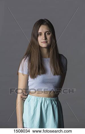 Picture - Portrait of beautiful woman standing against gray background. Fotosearch