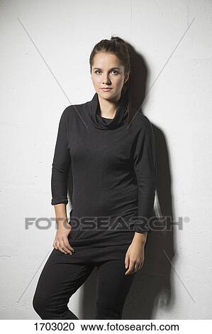 Portrait of beautiful woman standing against white background View Large Photo Image Stock Image - Portrait of beautiful woman standing against white background. Fotosearch