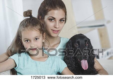 Portrait of beautiful young woman with daughter and dog at home View Large Photo Image Stock Image - Portrait of beautiful young woman with daughter and dog at home. Fotosearch