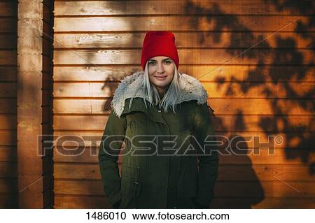 Portrait of confident beautiful woman standing against wall View Large Photo Image Stock Image - Portrait of confident beautiful woman standing against wall. Fotosearch