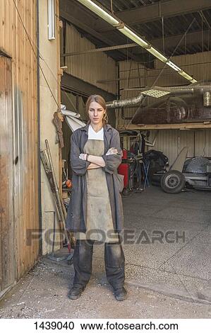 Portrait of confident female mechanic standing arms crossed at garage View Large Photo Image Stock Image - Portrait of confident female mechanic standing arms crossed at garage. Fotosearch