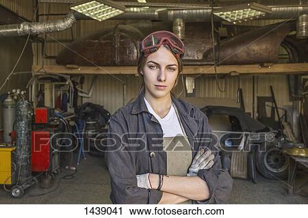 Portrait of confident female mechanic with arms crossed at garage View Large Photo Image Stock Image - Portrait of confident female mechanic with arms crossed at garage. Fotosearch