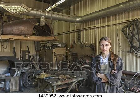 Portrait of confident female mechanic with arms crossed at repair shop View Large Photo Image Stock Image - Portrait of confident female mechanic with arms crossed at repair shop. Fotosearch