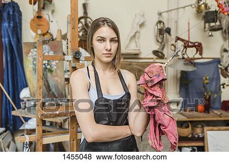 Portrait of confident female painter standing in studio View Large Photo Image Stock Photo - Portrait of confident female painter standing in studio. Fotosearch