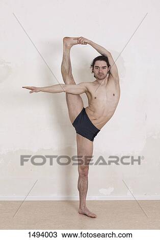 Portrait of confident man performing yoga against white background View Large Photo Image Stock Image - Portrait of confident man performing yoga against white background. Fotosearch