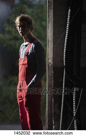 Portrait of confident mechanic standing in garage View Large Photo Image Stock Image - Portrait of confident mechanic standing in garage. Fotosearch