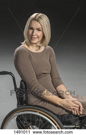Portrait of confident woman sitting in wheelchair View Large Photo Image Stock Image - Portrait of confident woman sitting in wheelchair. Fotosearch
