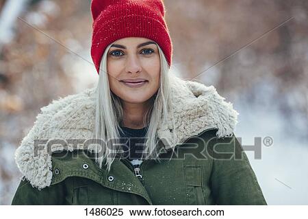 Portrait of confident young woman standing outdoors during winter View Large Photo Image Stock Photography - Portrait of confident young woman standing outdoors during winter. Fotosearch