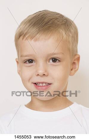 Portrait of cute boy against white background View Large Photo Image Stock Image - Portrait of cute boy against white background. Fotosearch