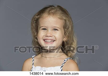Portrait of cute girl against gray background View Large Photo Image Picture - Portrait of cute girl against gray background. Fotosearch