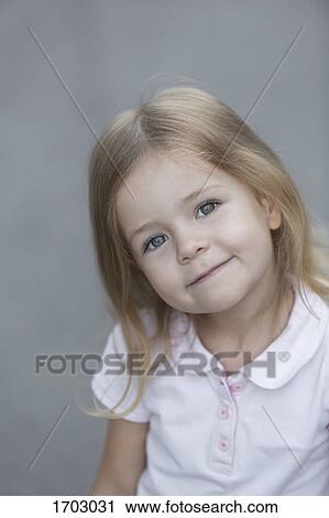 Stock Image - Portrait of cute girl against gray background. Fotosearch