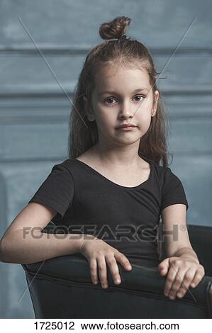 Portrait of cute girl sitting on armchair at home View Large Photo Image Stock Image - Portrait of cute girl sitting on armchair at home. Fotosearch