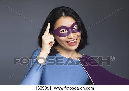 Portrait of excited female superhero gesturing against gray background View Large Photo Image Stock Image - Portrait of excited female superhero gesturing against gray background. Fotosearch