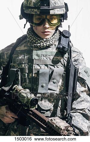 Portrait of female soldier carrying rifle and standing against white background View Large Photo Image Stock Photograph - Portrait of female soldier carrying rifle and standing against white background. Fotosearch
