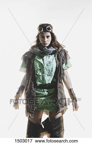 Portrait of furious woman wearing goggles and jacket standing against white background View Large Photo Image Stock Photo - Portrait of furious woman wearing goggles and jacket standing against white background. Fotosearch