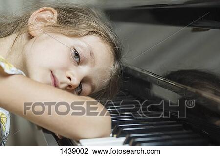 Portrait of girl leaning on piano View Large Photo Image Stock Image - Portrait of girl leaning on piano. Fotosearch