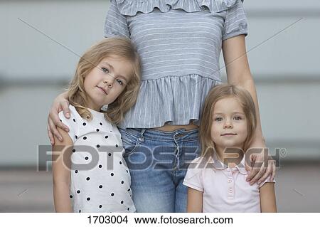 Portrait of girls standing with mother View Large Photo Image Picture - Portrait of girls standing with mother. Fotosearch