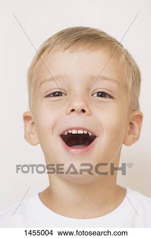 Portrait of happy boy against white background View Large Photo Image Picture - Portrait of happy boy against white background. Fotosearch