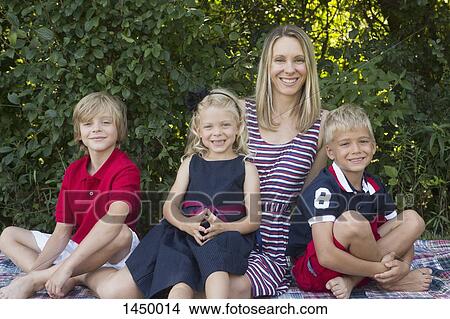 Portrait of happy family sitting at backyard View Large Photo Image Picture - Portrait of happy family sitting at backyard. Fotosearch