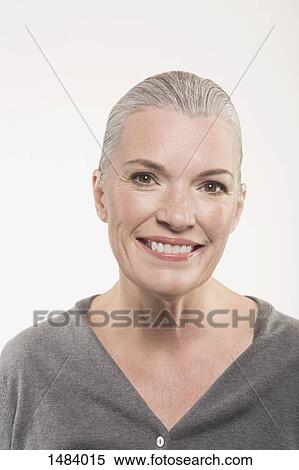 Portrait of happy mature woman against white background View Large Photo Image Stock Photography - Portrait of happy mature woman against white background. Fotosearch