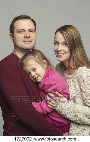 Portrait of happy parents with daughter against gray background View Large Photo Image Stock Image - Portrait of happy parents with daughter against gray background. Fotosearch
