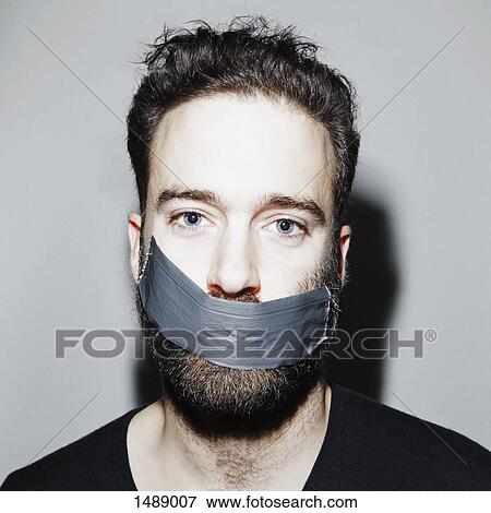 Portrait of man with adhesive tape covering his mouth View Large Photo Image Stock Photo - Portrait of man with adhesive tape covering his mouth. Fotosearch