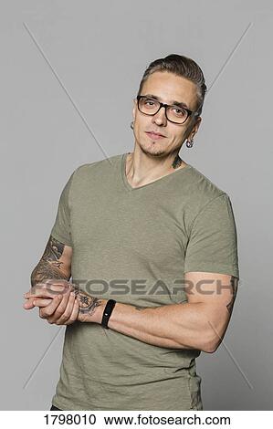 Portrait of man with glasses and hands clasped against gray background View Large Photo Image Stock Image - Portrait of man with glasses and hands clasped against gray background. Fotosearch