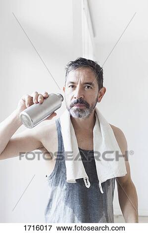 Portrait of mature man holding water bottle View Large Photo Image Stock Photo - Portrait of mature man holding water bottle. Fotosearch
