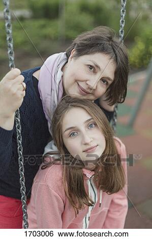 Portrait of senior woman with granddaughter on swing at playground View Large Photo Image Stock Photograph - Portrait of senior woman with granddaughter on swing at playground. Fotosearch