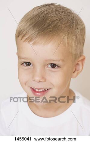 Portrait of smiling boy against white background View Large Photo Image Stock Image - Portrait of smiling boy against white background. Fotosearch