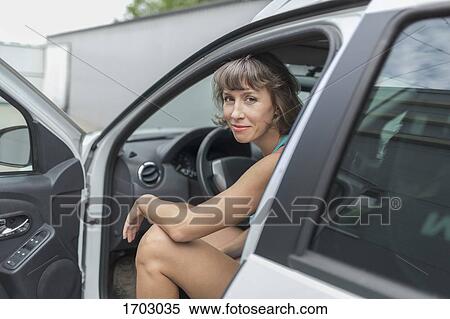 Portrait of smiling mature woman sitting in car View Large Photo Image Stock Photography - Portrait of smiling mature woman sitting in car. Fotosearch