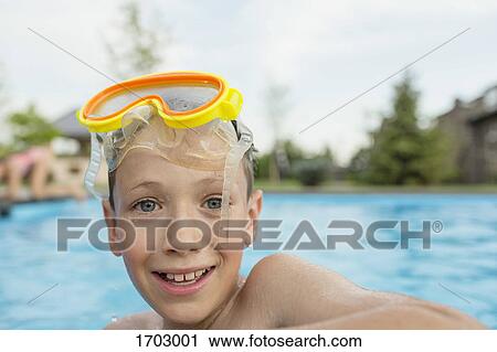 Portrait of smiling shirtless boy with swimming goggles in pool View Large Photo Image Stock Image - Portrait of smiling shirtless boy with swimming goggles in pool. Fotosearch