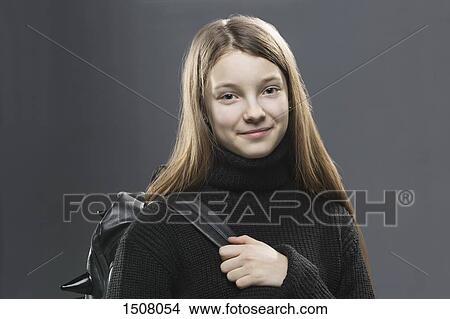 Portrait of smiling student standing against gray background View Large Photo Image Picture - Portrait of smiling student standing against gray background. Fotosearch