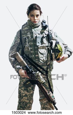 Portrait of soldier holding rifle and helmet standing against white background View Large Photo Image Picture - Portrait of soldier holding rifle and helmet standing against white background. Fotosearch