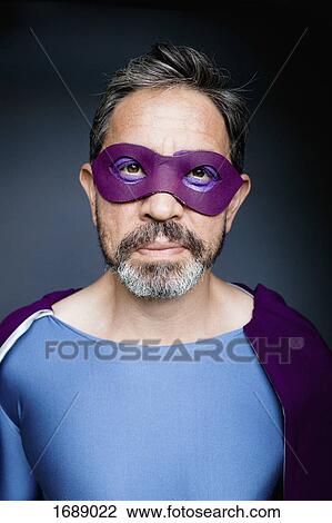 Portrait of superhero against gray background View Large Photo Image Stock Image - Portrait of superhero against gray background. Fotosearch