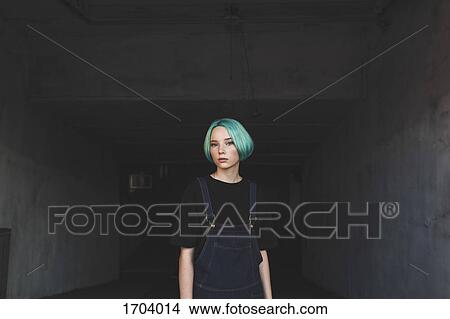 Portrait of teenage girl standing in basement View Large Photo Image Picture - Portrait of teenage girl standing in basement. Fotosearch
