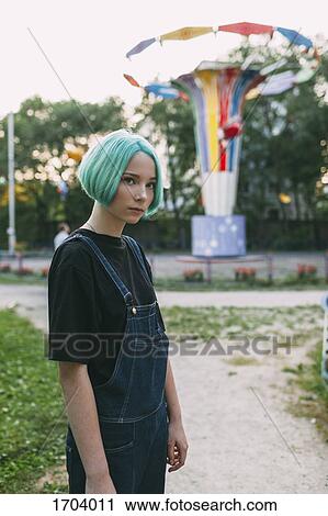 Portrait of teenage girl standing against amusement park ride View Large Photo Image Stock Image - Portrait of teenage girl standing against amusement park ride. Fotosearch