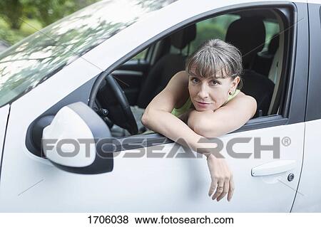 Portrait of woman resting in car View Large Photo Image Stock Photo - Portrait of woman resting in car. Fotosearch
